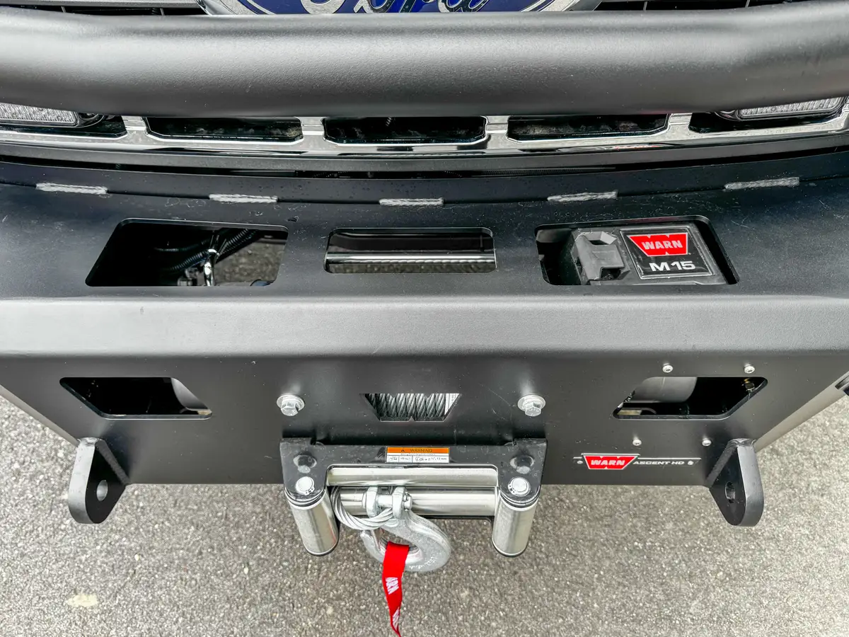 Front fender close-up with side marker light and brush guard tube.